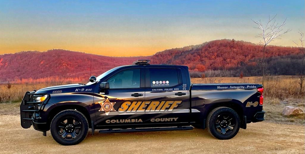 Image of a Columbia County Sheriff's Office truck parked amid a backdrop of a wooded ridge.